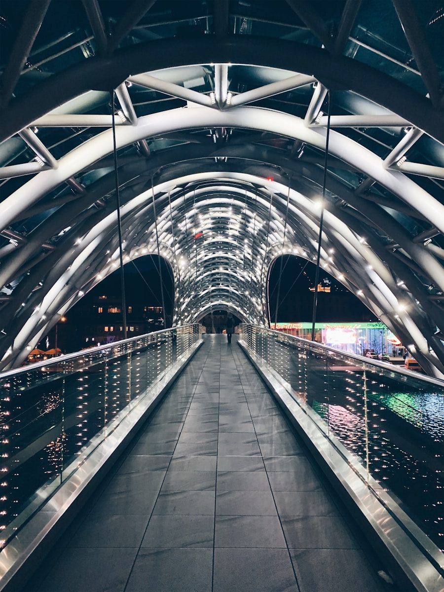 gray metal bridge with green lights